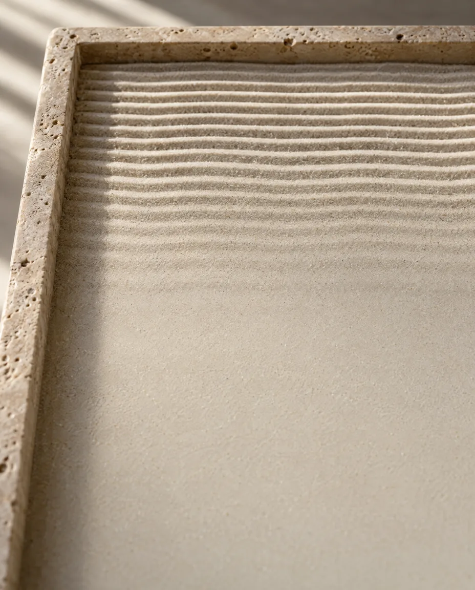 Raked sand fading into a smooth surface