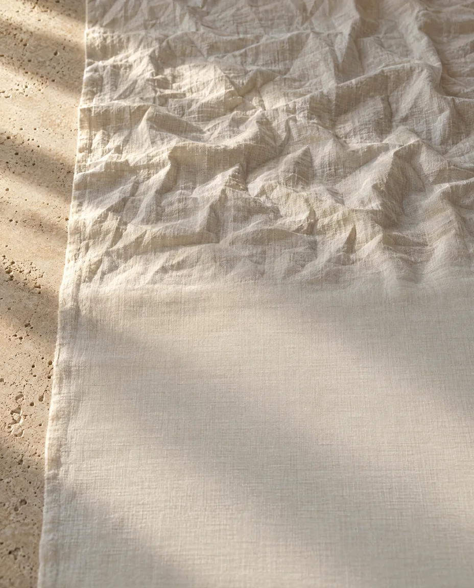 Linen cloth, creased at the top and smooth below